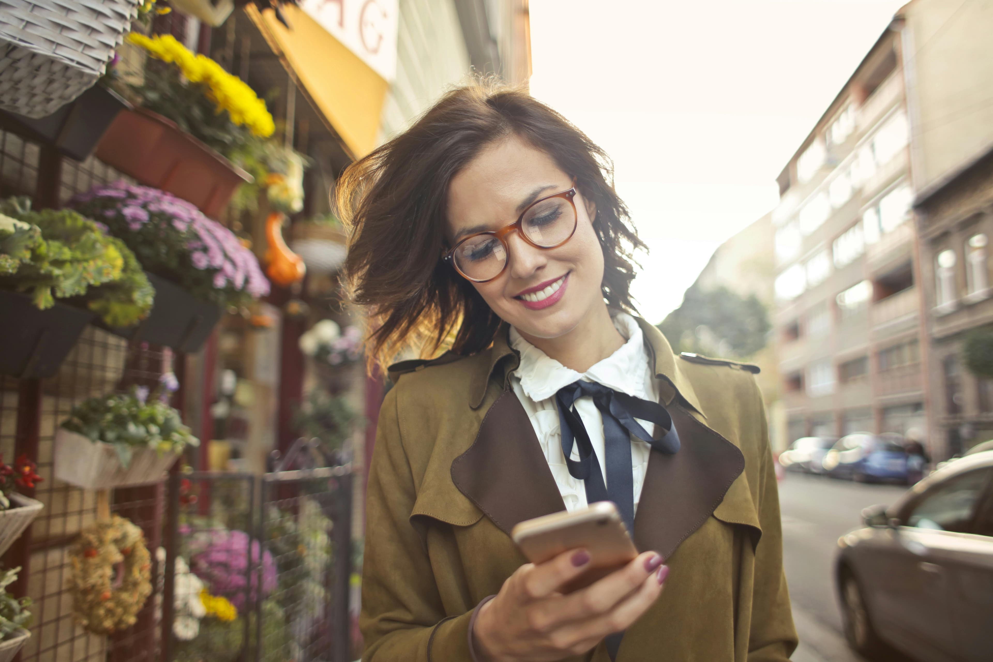 Smiling woman using phone
